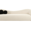 Modern curved beige sofa front view with two black round pillows on the left